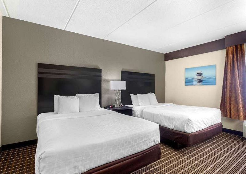 Cozy one-bedroom suite at Sleep Inn & Suites West Knoxville, featuring a king-sized bed, work desk, and flat-screen TV