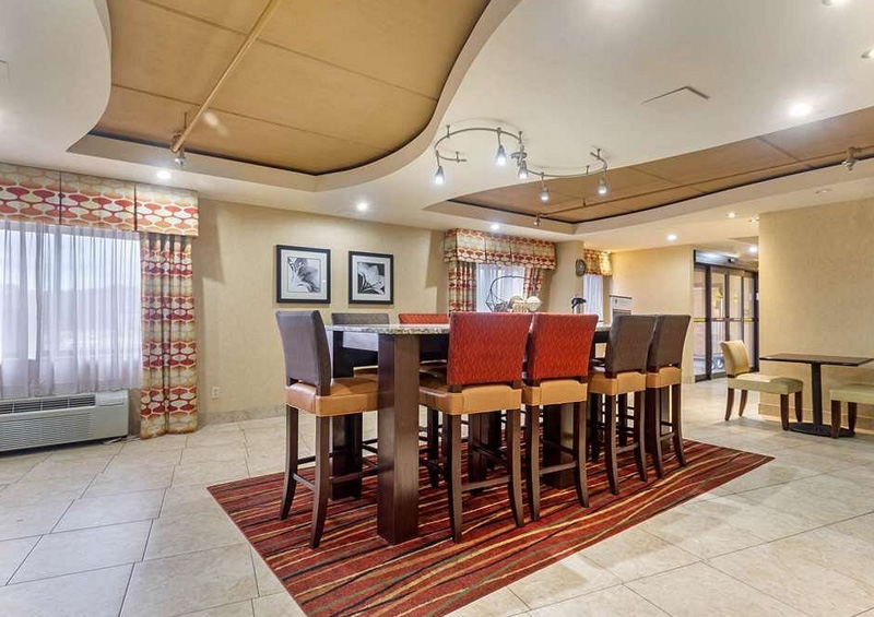 Bright and inviting breakfast area at Sleep Inn & Suites West Knoxville, featuring a variety of seating options and a buffet of hot and cold items